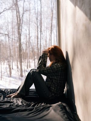 Side,View,Of,Depressed,Young,Woman,Sitting,On,Sunny,Day